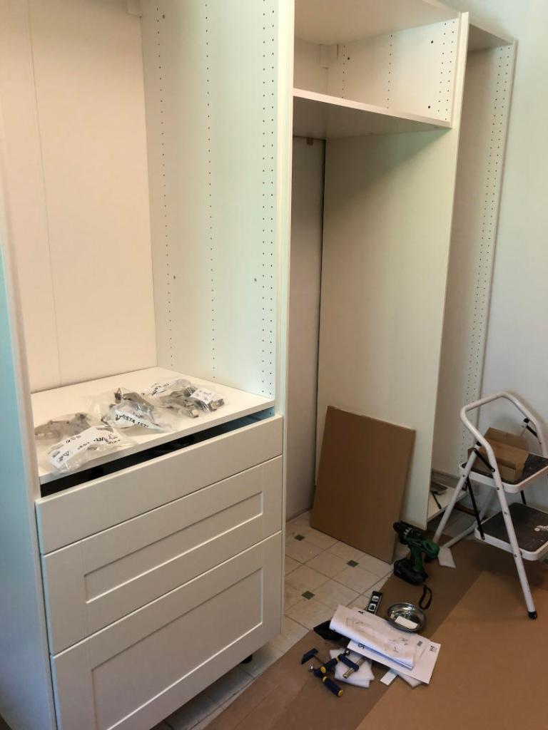 photo of the three new cabinets--two high cabinets, one with three drawers of varying depths, a fridge cabinet and the 18" cabinet I plan to use as a broom closet. 