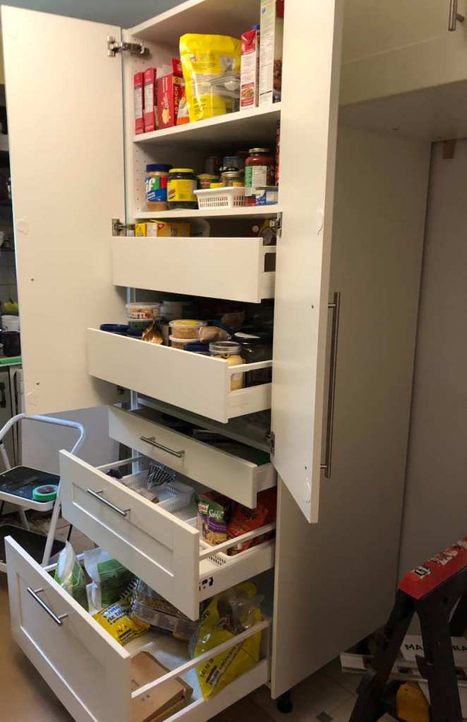photo of the high-cabinet we will be using as a pantry, with two shelves at the top, two internal drawers behind two doors, and three external drawers in 5", 10" and 15" size all with the Grimslov (off-white) doors and drawer fronts.
