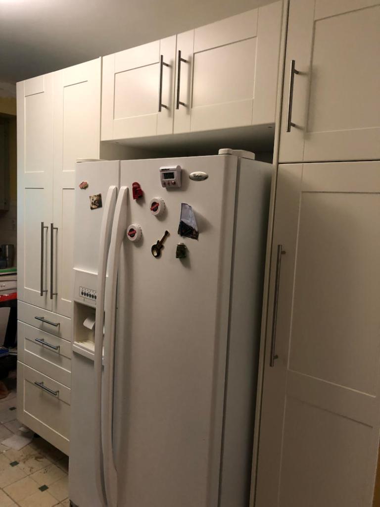 photo of my high cabin, French door fridge with the cabinet  over it, and the cleaning cabinet, all complete with handles in place